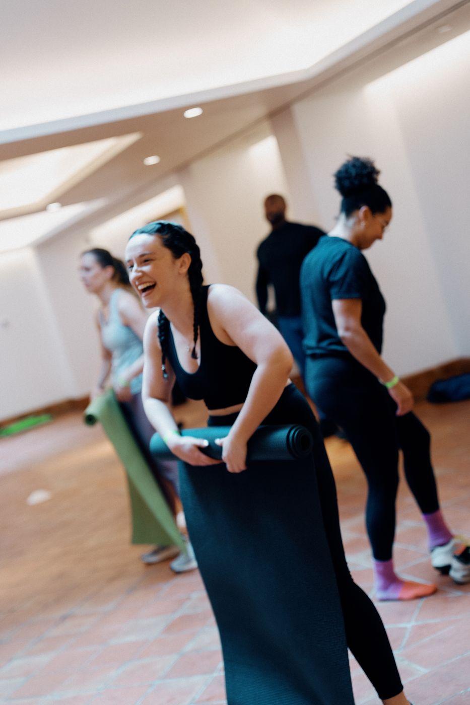 Guests laughing after a Peared yoga class
